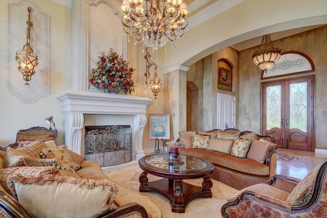 living room with tile patterned flooring, a notable chandelier, french doors, and ornate columns