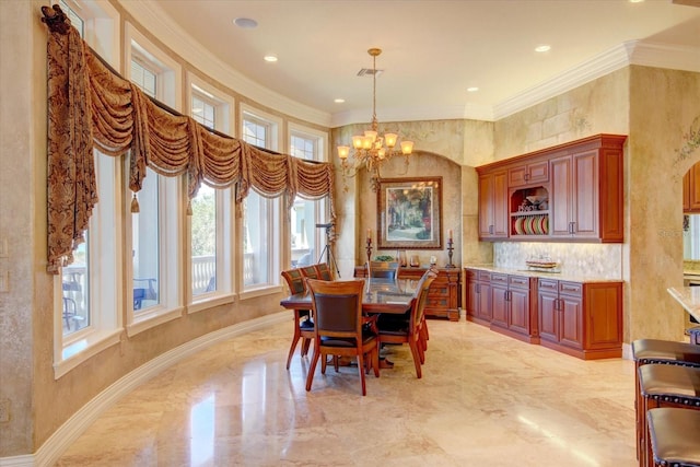 dining room featuring light tile patterned flooring, ornamental molding, and a notable chandelier