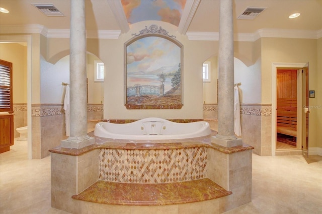 bathroom with a healthy amount of sunlight, tile patterned floors, and decorative columns