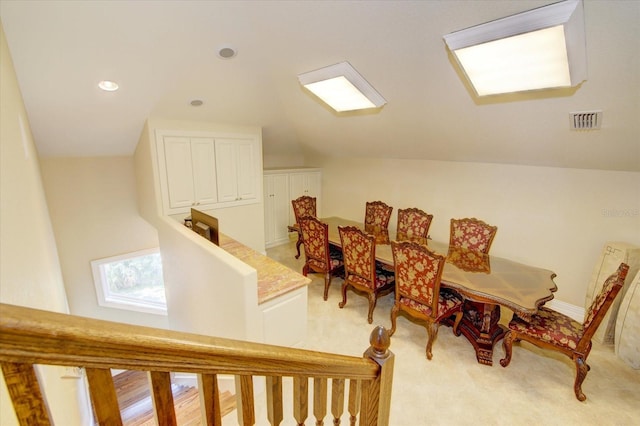 interior space with lofted ceiling and light carpet