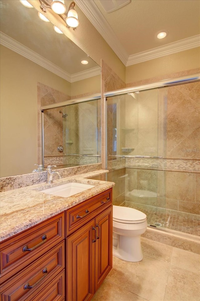 bathroom featuring vanity, ornamental molding, and toilet