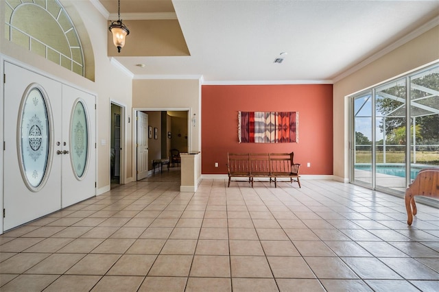 foyer with baseboards, french doors, light tile patterned flooring, and crown molding