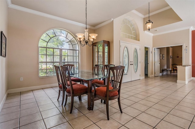 dining space with baseboards, ornamental molding, an inviting chandelier, a high ceiling, and light tile patterned flooring