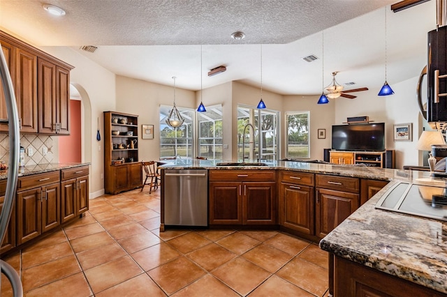 kitchen featuring a sink, tasteful backsplash, visible vents, and stainless steel dishwasher