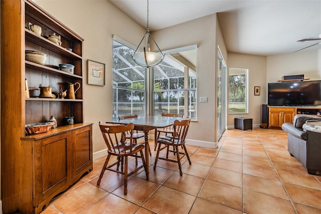 dining room featuring light tile patterned flooring and baseboards