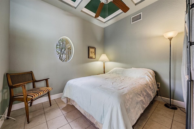 bedroom with tile patterned flooring, visible vents, coffered ceiling, and baseboards