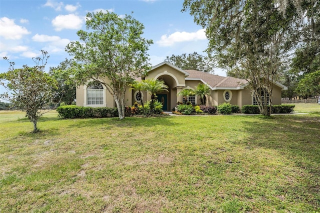 view of front of home featuring a front yard and stucco siding