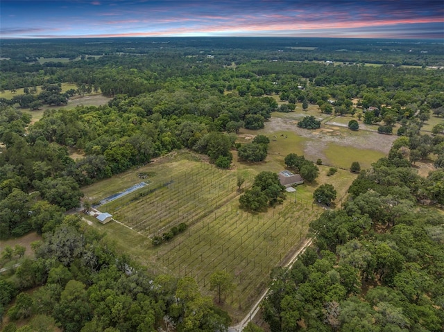 aerial view at dusk with a rural view and a forest view