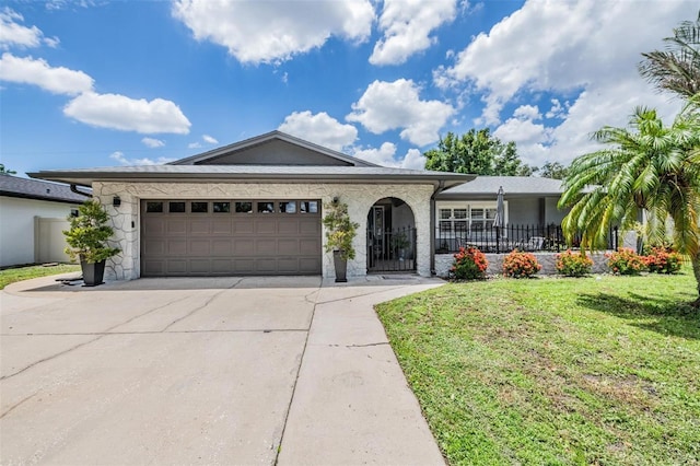 ranch-style house with a garage, covered porch, and a front lawn