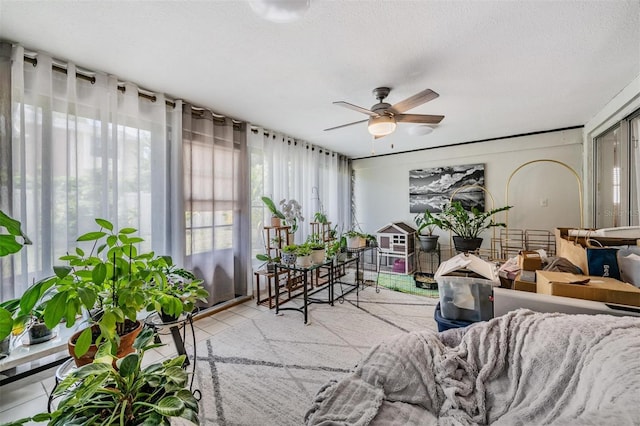 sunroom featuring ceiling fan