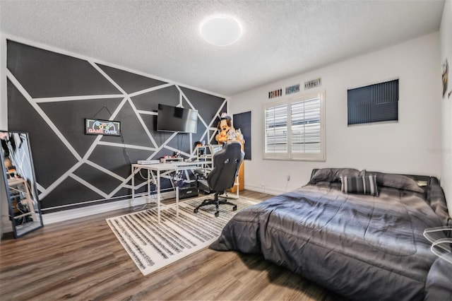 bedroom featuring a textured ceiling and wood-type flooring