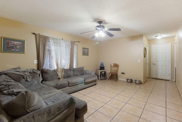 tiled living room featuring ceiling fan and a textured ceiling