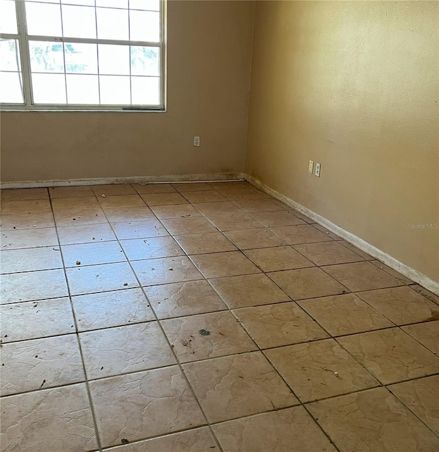 spare room with baseboards