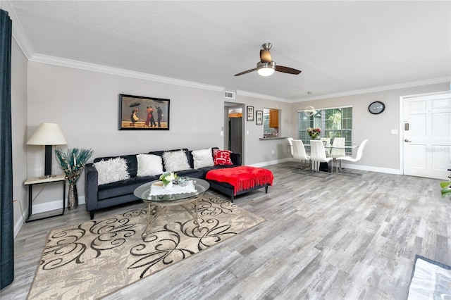 living room with ceiling fan, light hardwood / wood-style flooring, and ornamental molding