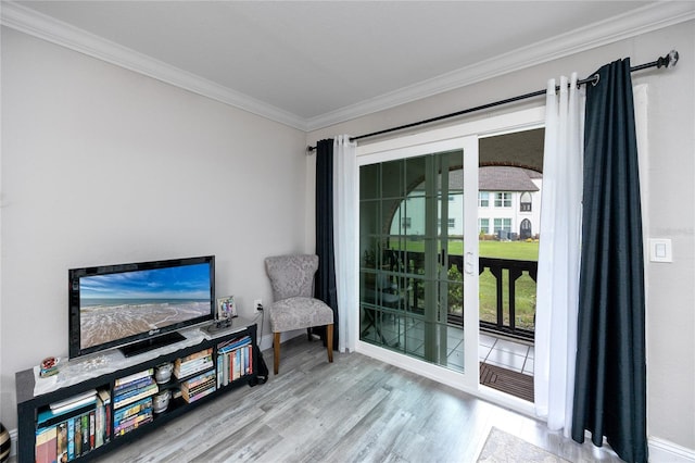 living area featuring wood-type flooring and ornamental molding