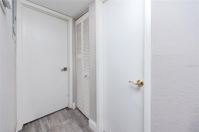 corridor with light hardwood / wood-style flooring