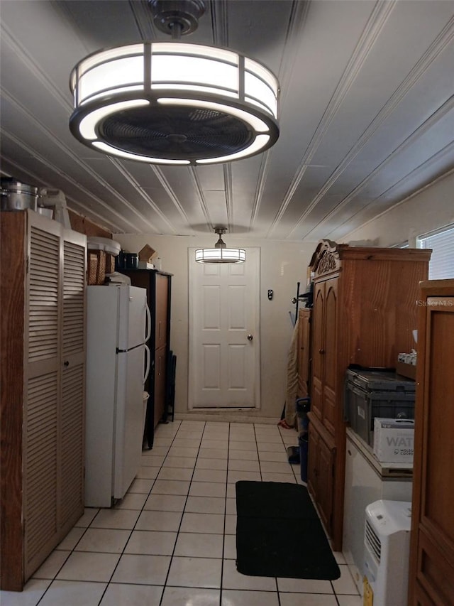 kitchen with white fridge and light tile patterned floors