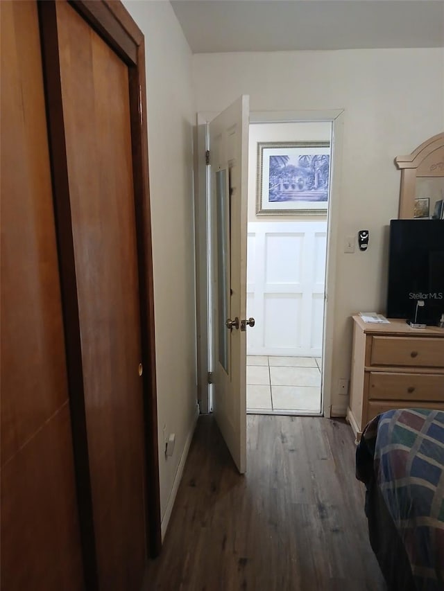 bedroom featuring dark hardwood / wood-style floors and a closet