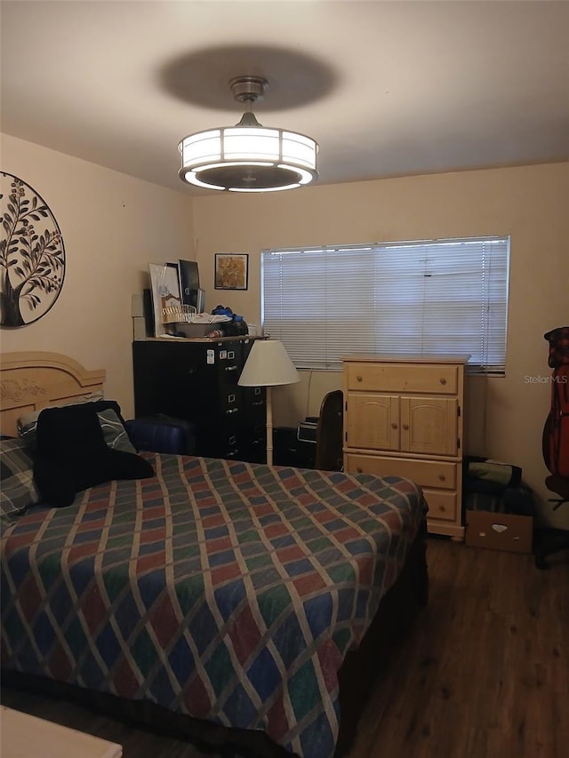 bedroom with dark hardwood / wood-style floors