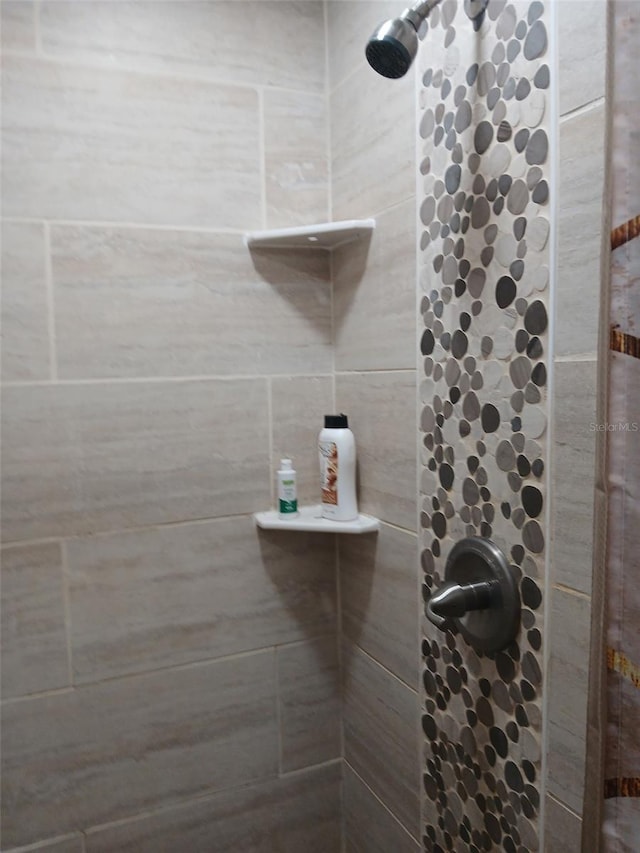 bathroom with tiled shower