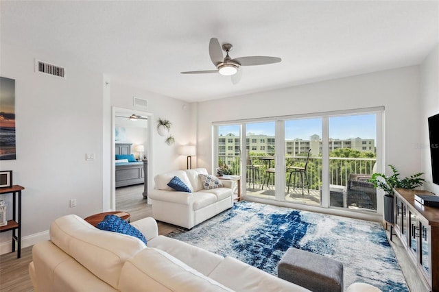 living room with ceiling fan and light wood-type flooring