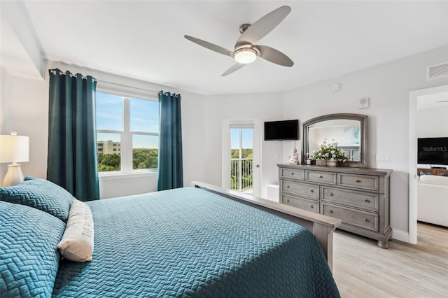 bedroom with light hardwood / wood-style flooring, access to outside, and ceiling fan