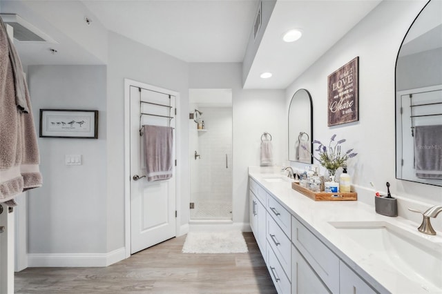 bathroom featuring vanity, hardwood / wood-style floors, and an enclosed shower