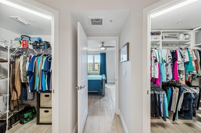 spacious closet featuring light hardwood / wood-style floors