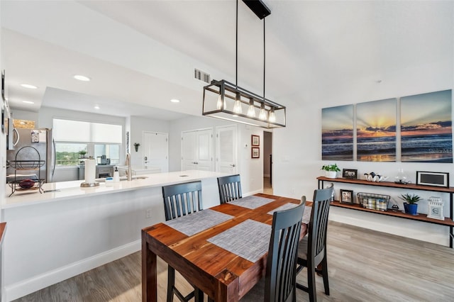 dining area featuring sink and light wood-type flooring