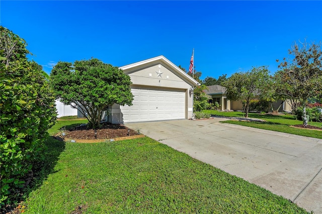 view of front of house featuring a garage and a front lawn