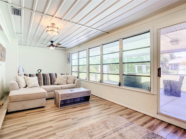 living room with light hardwood / wood-style floors and ceiling fan