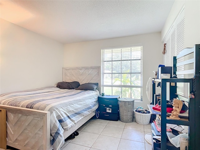 tiled bedroom with a textured ceiling