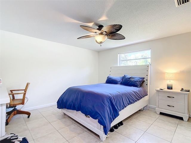 tiled bedroom featuring a textured ceiling and ceiling fan