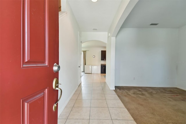 view of carpeted foyer entrance