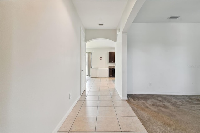 corridor featuring light tile patterned floors