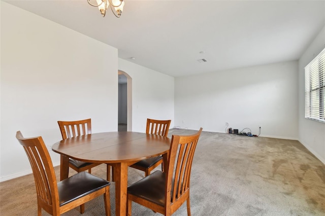 dining area featuring light colored carpet