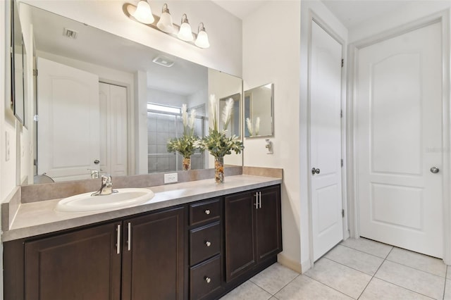 bathroom with tile patterned flooring and vanity