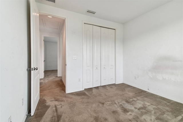 unfurnished bedroom with a closet and carpet