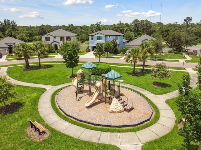 view of community featuring a playground and a lawn