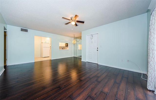 unfurnished room with a textured ceiling, dark hardwood / wood-style floors, and ceiling fan