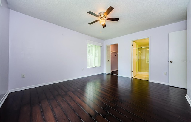 unfurnished room featuring dark wood-type flooring, a textured ceiling, and ceiling fan