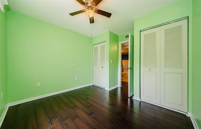 unfurnished bedroom with dark hardwood / wood-style floors and ceiling fan