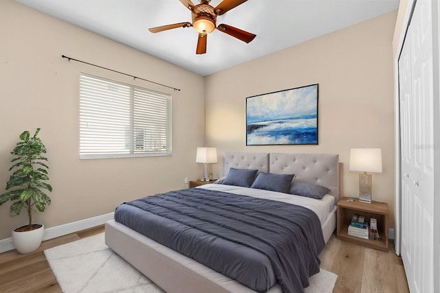 bedroom featuring a closet, ceiling fan, and light hardwood / wood-style flooring