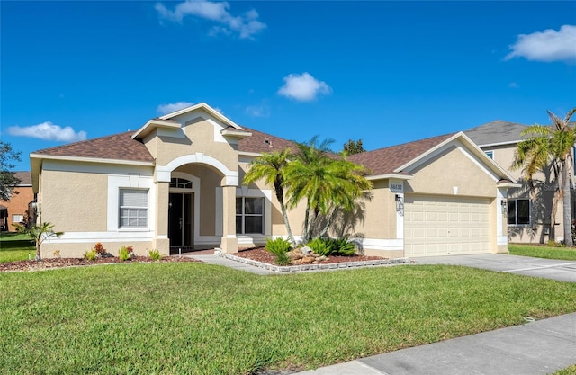 view of front of home featuring a front yard and a garage