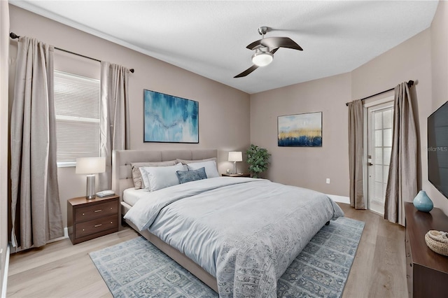 bedroom with ceiling fan and light wood-type flooring