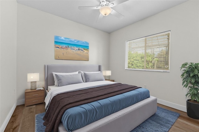 bedroom with hardwood / wood-style floors and ceiling fan