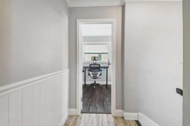 hall featuring light hardwood / wood-style floors and ornamental molding