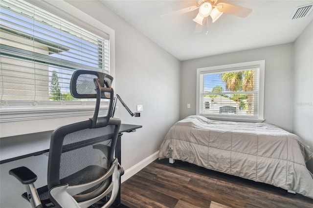 bedroom with dark hardwood / wood-style floors and ceiling fan