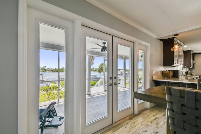 doorway to outside featuring sink, ornamental molding, french doors, and light hardwood / wood-style floors