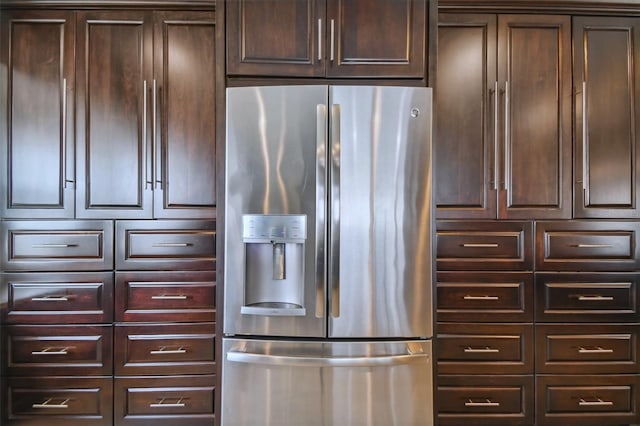 kitchen featuring stainless steel fridge with ice dispenser and dark brown cabinetry